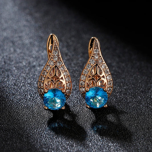 Boucles d'oreilles arabesques et zircons bleus et blancs, bijou en plaqué or rose