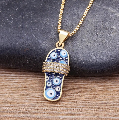 collier avec pendentif slash avec motif oeil turc et zircons